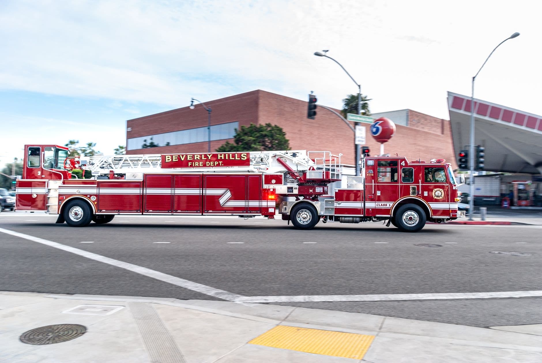 Beverly Hills fire truck driving through a city street, showcasing emergency services in action.