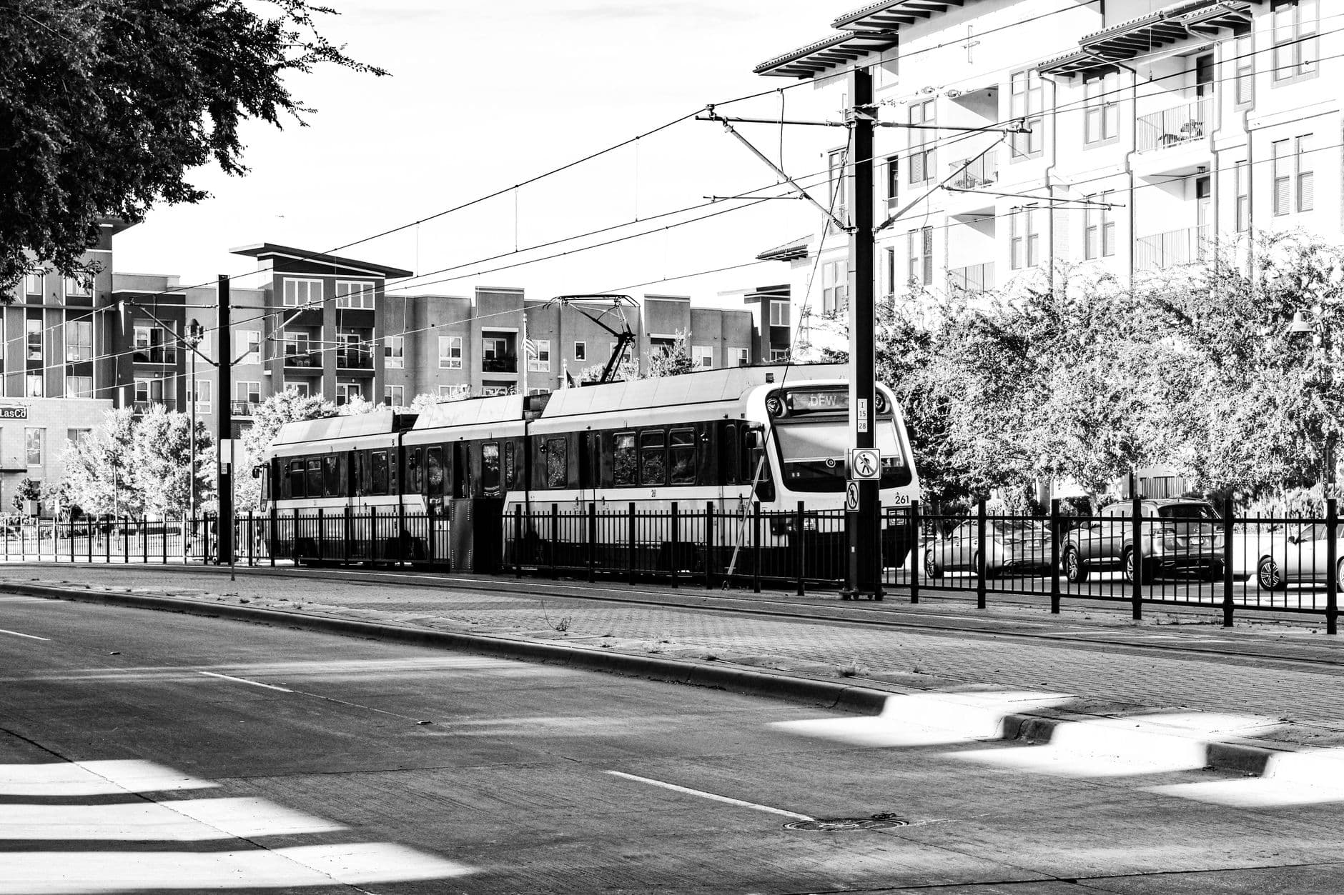 Monochrome tram on street in Irving, Texas, showcasing urban transportation.