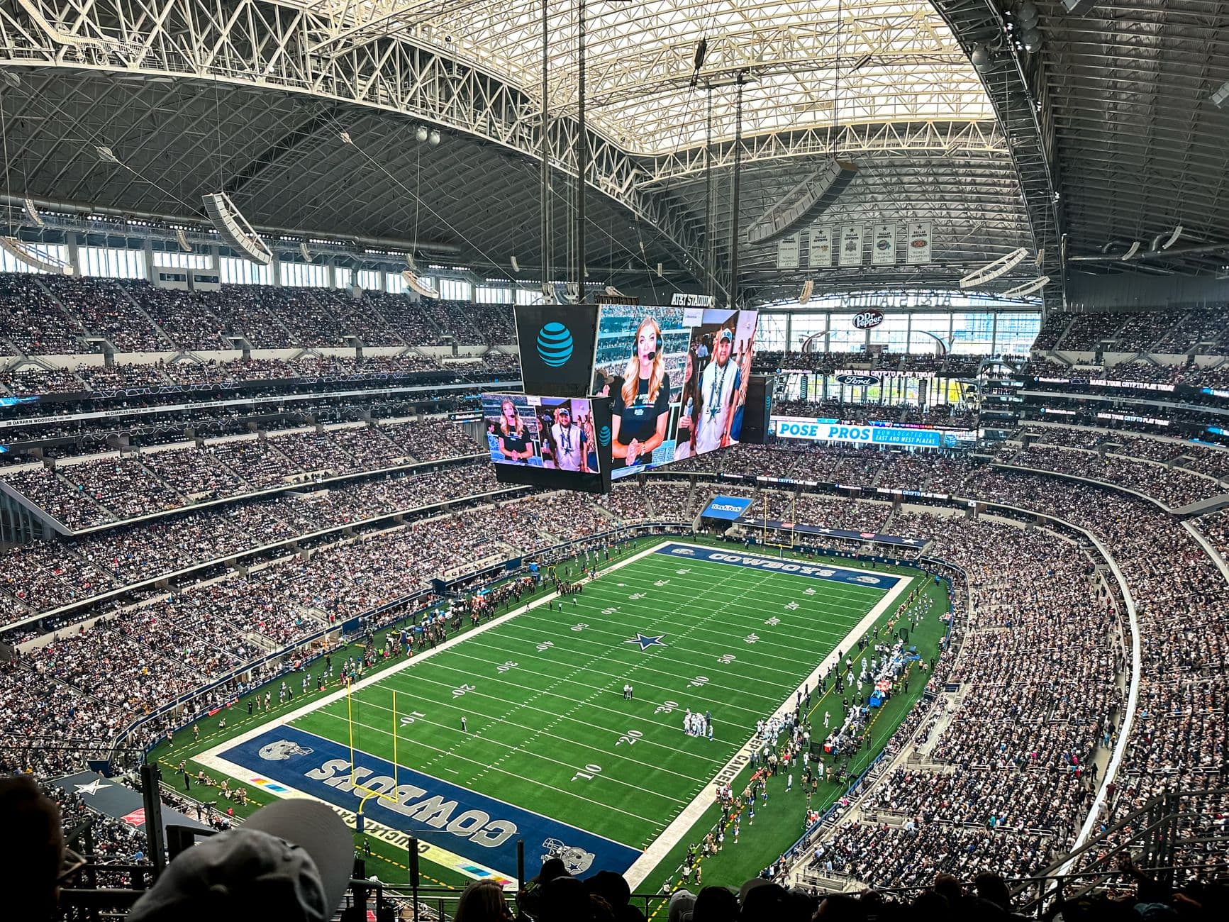 A packed AT&T Stadium in Arlington, Texas, showcasing a thrilling football game with enthusiastic fans.